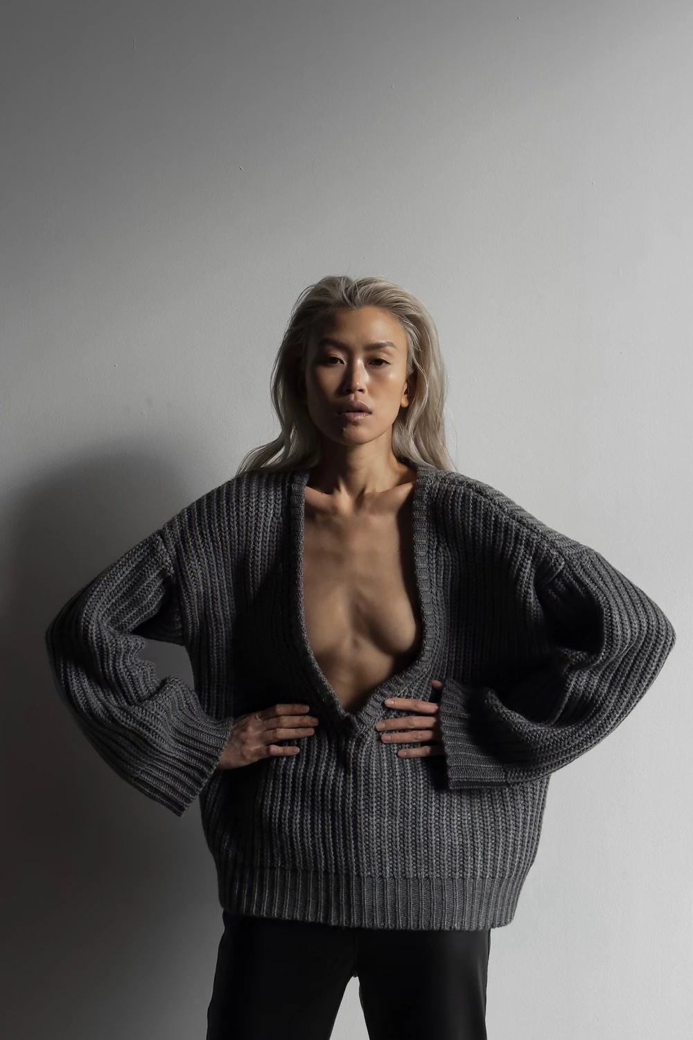 sweater with a deep v-neck sleeve in grey color